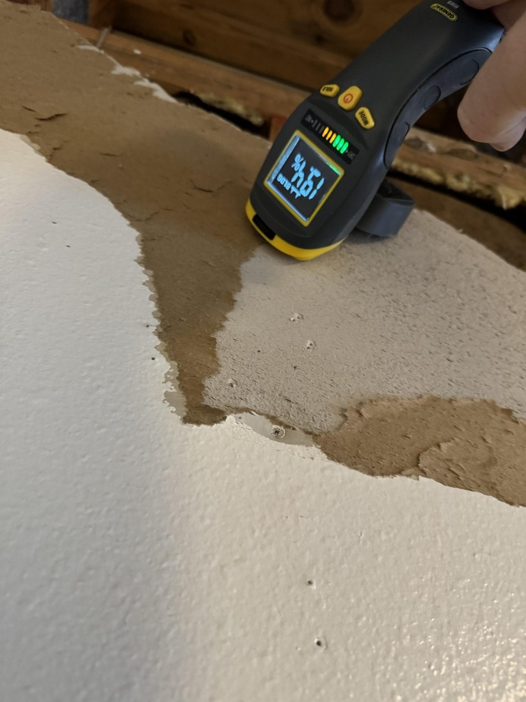 Moisture meter checking an exposed interior wall area