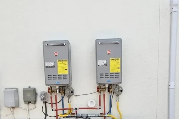 Two outdoor tankless water heaters installed side by side