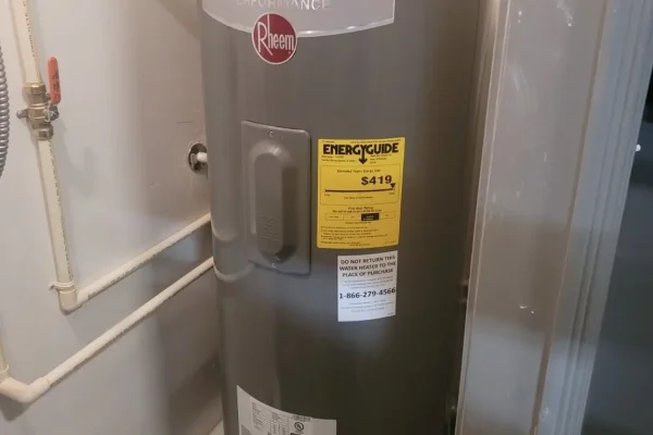 Electric tank water heater installation in a utility space