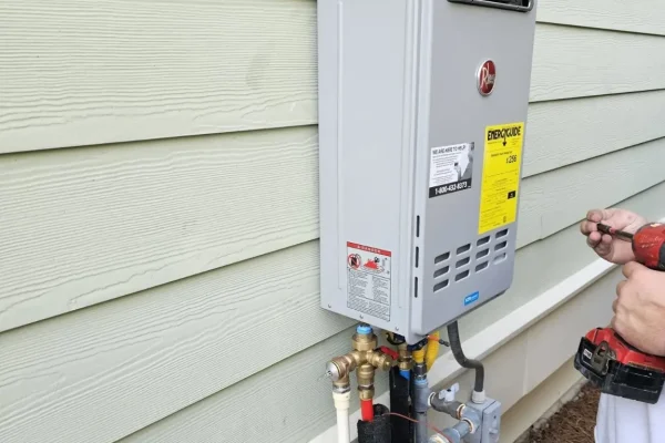 Exterior tankless water heater installation with new piping